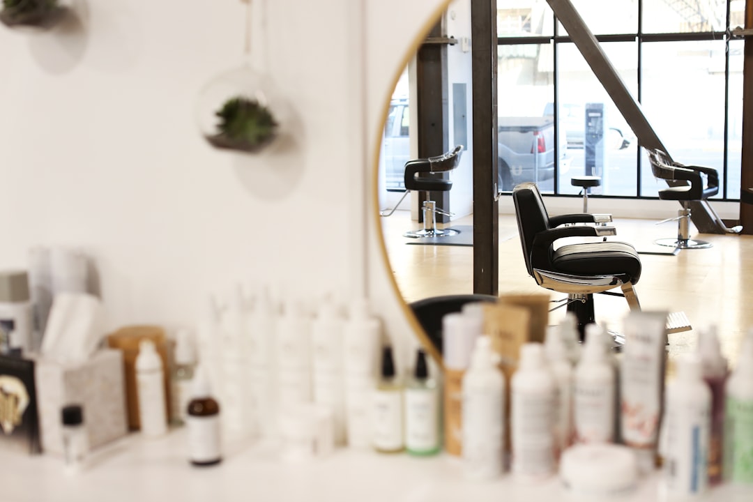 A stylist finishing a blow-dry in a bright salon
